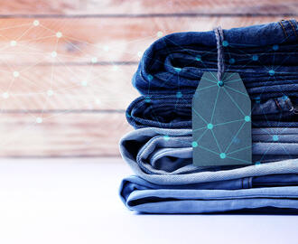 A stack of jeans with network/AI imagery overlayed on top