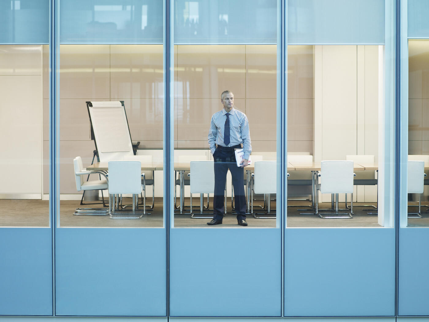 Man looking out office widow